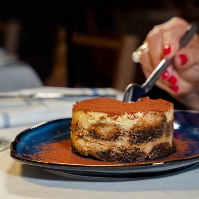 Tiramisu dessert dusted with cocoa powder.