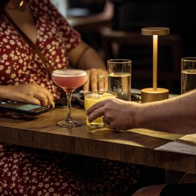 Guests at a table with served drinks.