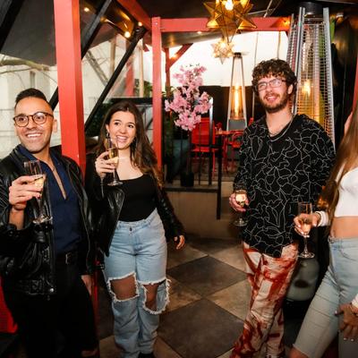 Personnel holding drinks and smiling inside.