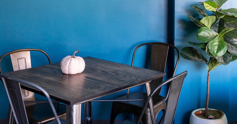 Interior, table with four chairs with picture on the wall