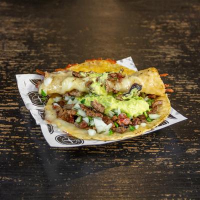 Steak tacos, with cilantro, onions, and avocado sauce.