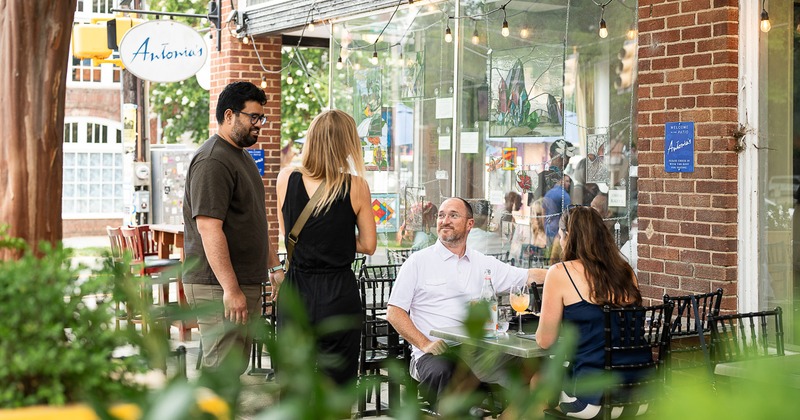 Exterior,  side walk patio, table, chairs, people