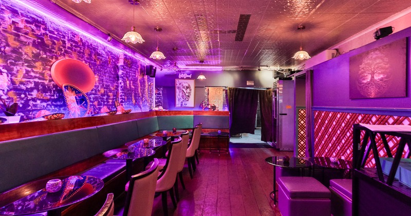 Diner area, tables, armchairs, door with curtain behind