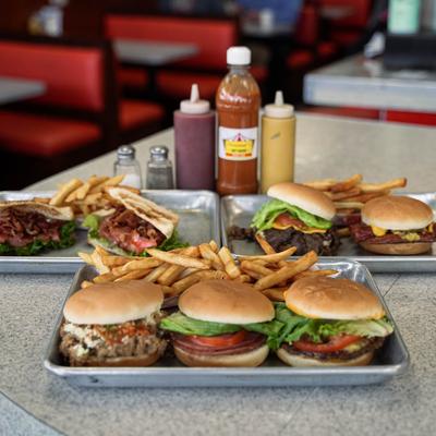 Various sandwiches with fries.