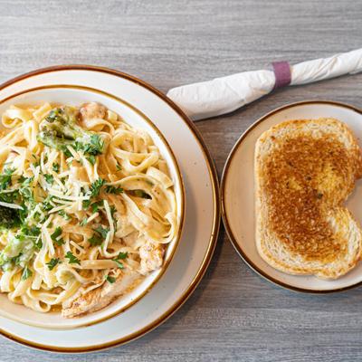Chicken and Broccoli Fettuccine Alfredo with bread on the side.