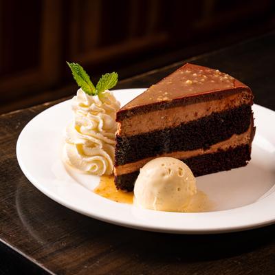 Chocolate hazelnut cake with ice cream and whipped cream.