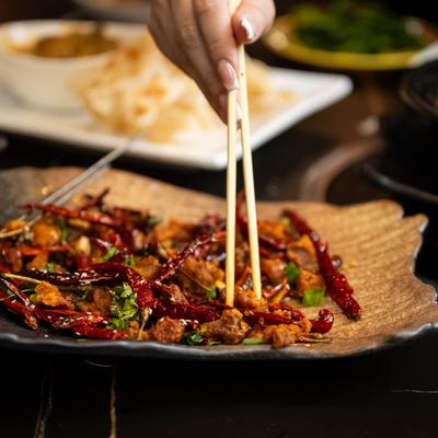 A person enjoying Spicy Diced Chicken.