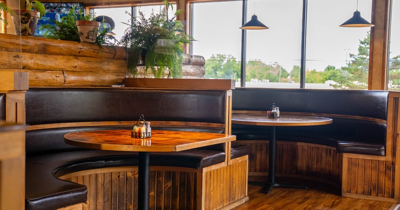 Interior seating area with wooden booths and dark leather seating