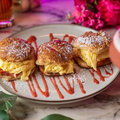 French Toast Breakfast Sliders with scrambled eggs, turkey bacon, and cheddar.