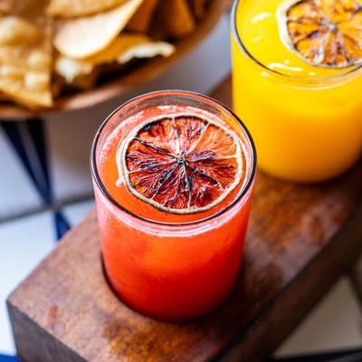 Close up of red and yellow margaritas on a flight.