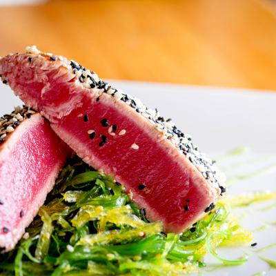 Sesame-crusted tuna over wakame salad.