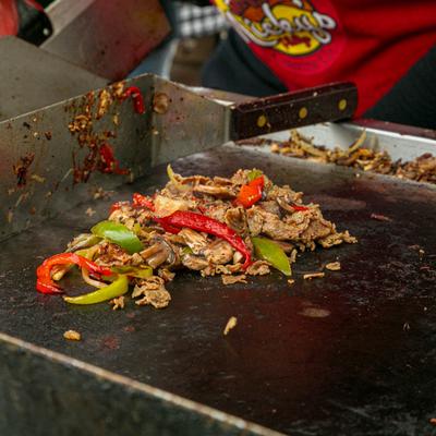 Meat and vegetables cooking on a grill.