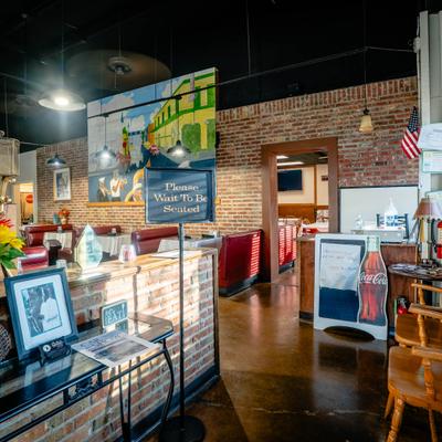 Entrance area featuring exposed brick walls and a large mural.