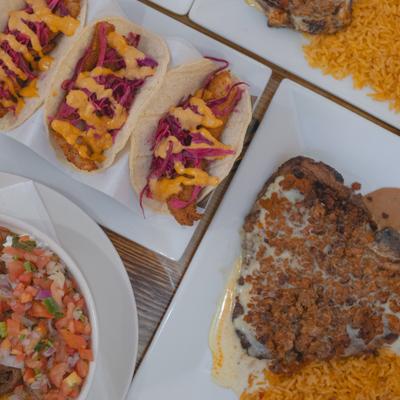 Fish tacos served with Mexican rice, pico de gallo, and steak with chorizo.