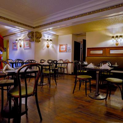 Restaurant interior with set tables and wall art.