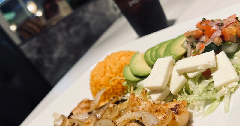 Grilled chicken and shrimp, with onion, mushrooms, rice, avocado, feta, and salsa
