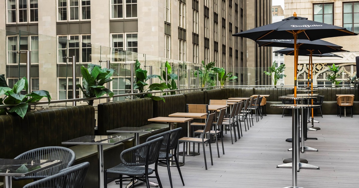 Exterior, terrace, partially covered seating area, tables with chairs, parasols