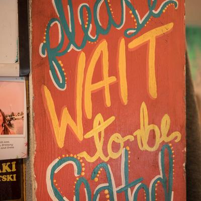 A painted announcement for guests on a board.