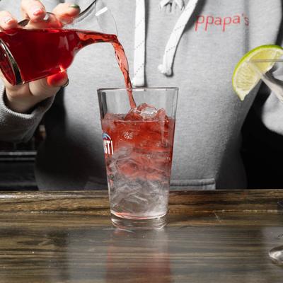 A bartender making Cosmo cocktail.