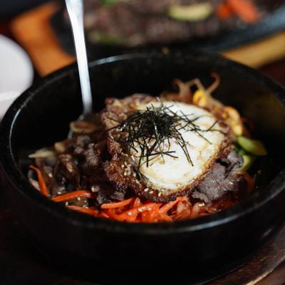 Thick noodle soup with fish cake, shrimp & vegetables with an egg.