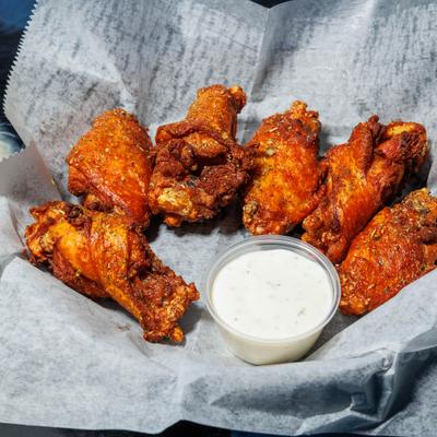 Dry rub traditional wings served with a dipping sauce.