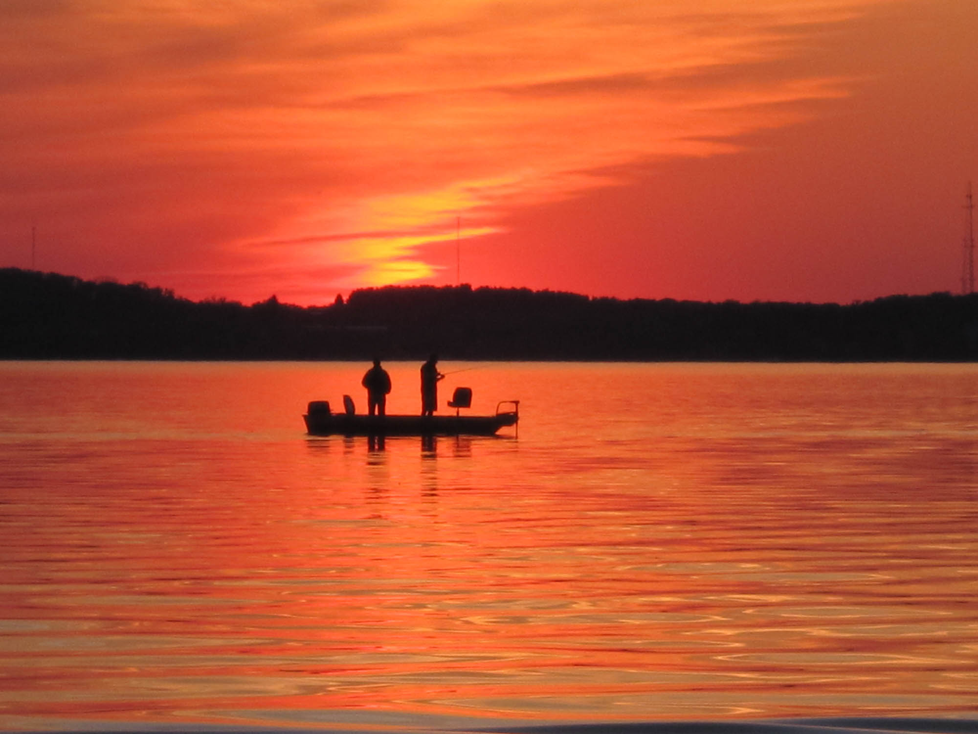 Sunset, boat on a lake