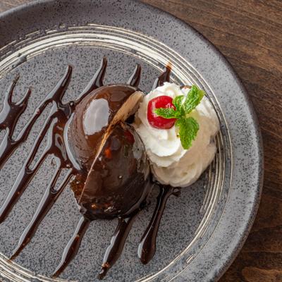 Hazelnut chocolate crunch garnished with whipped cream, cherry, and mint.