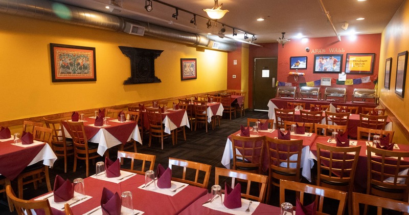 Interior, dining area, tables ready for guests, Nepali inspired decoration