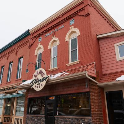 Sam's Finer exterior with a red brick facade and signage.