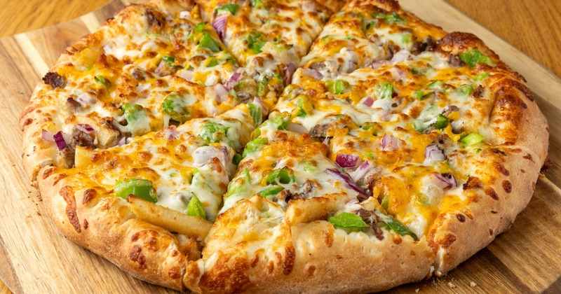 Genoa Special Pizza served on a rustic wooden paddle