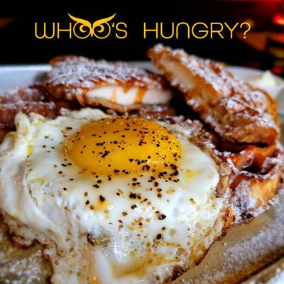 Chicken and wafle toped with syrup and fried egg.