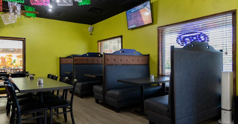 Interior, seating booths by the window, tables and chairs in the middle, TV on the wall