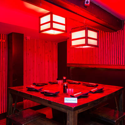 Corner seating under red lights.
