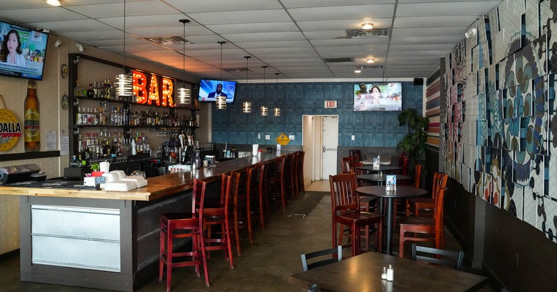 Interior, sitting place with tables and chairs near bar