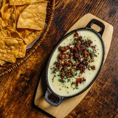 Melted asadero cheese topped with chorizo and served with chips.