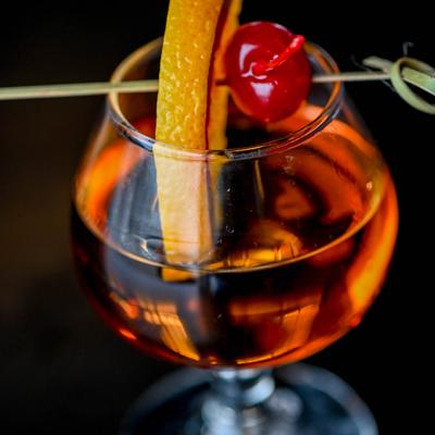 Old Fashioned garnished with lemon and cherry.