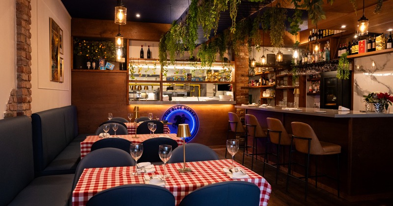 Elegant dining space with decorative plants and art on the walls