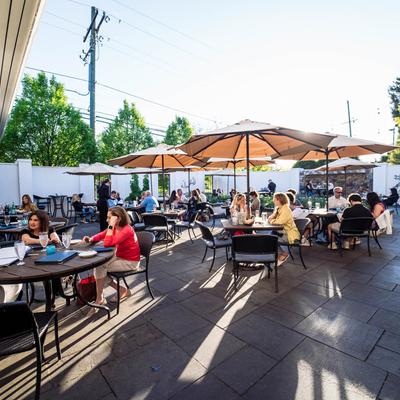 Busy outside seating area with parasols.