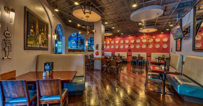 Interior of a restaurant with tables, chairs, and festive Halloween decorations