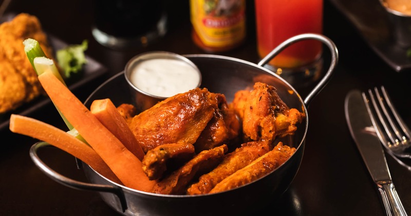 Buffalo Chicken Wings served with sauce dip and veggies