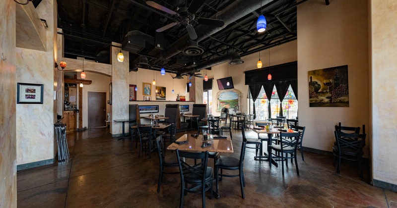 Interior, seating area, marble walls, tables and chairs, large window in the back