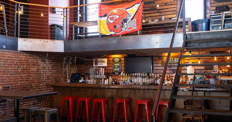 Interior bottom-level bar area, upstairs tables, and chairs