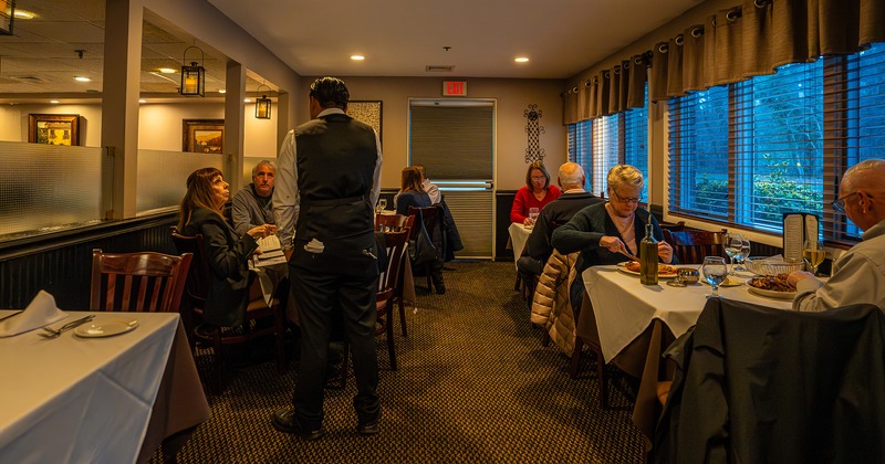 Restaurant interior, dining area, guests chatting and enjoying their food