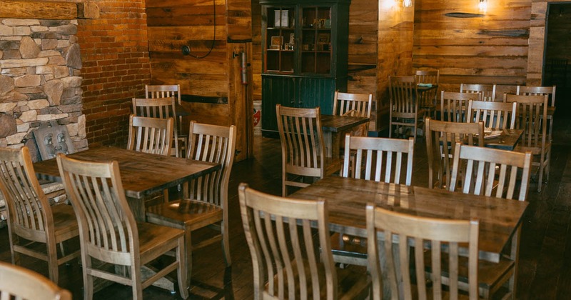 Interior, wooden tables and chairs ready for guests