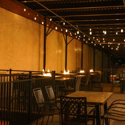 Upstairs dining area with string lights and dining tables.