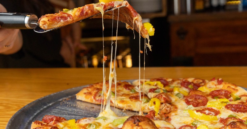 Pizza slice cheese pull shot