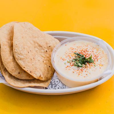 Creamy queso fundido served with toasted tortillas.
