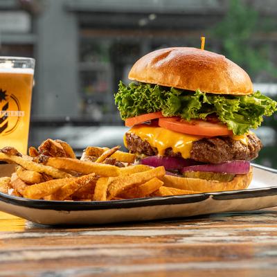 Cheeseburger with fries and a glass of beer.