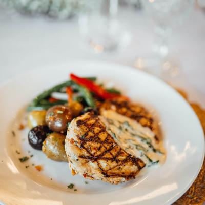 Grilled chicken with sauce and vegetables.