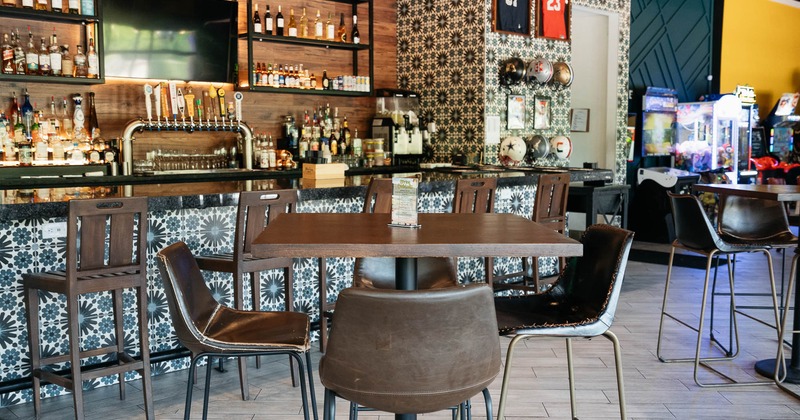 Interior, table and chairs near bar